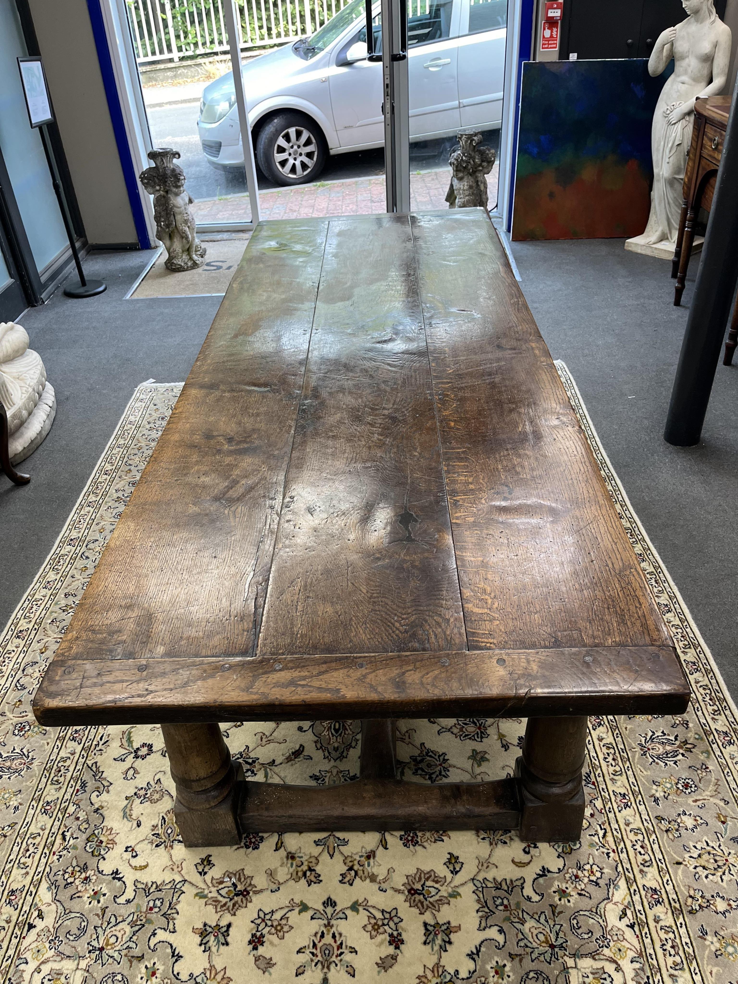 An 18th century style rectangular oak refectory dining table, width 243cm, depth 90cm, height 72cm. Condition - fair